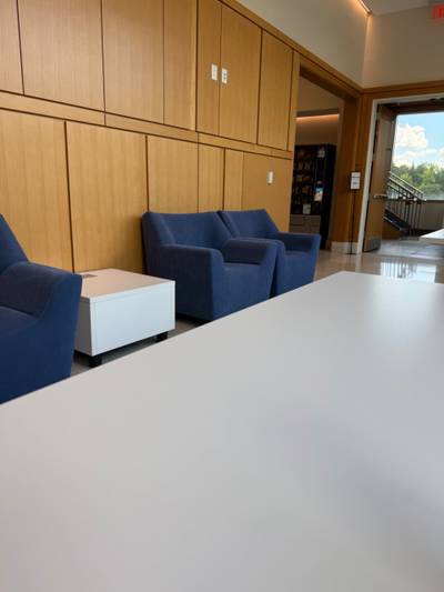 Lounge with blue armchairs near vending machines
