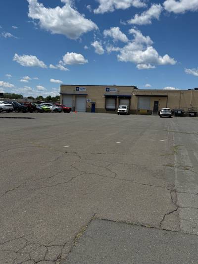 Warehouse loading bays with cracked asphalt lot