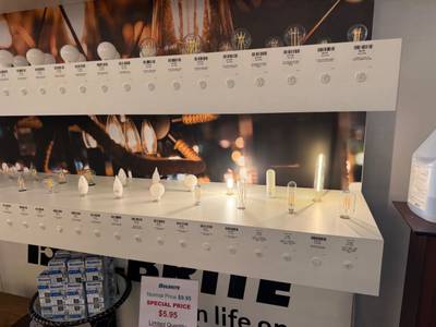 Illuminated shelves displaying filament LED bulbs