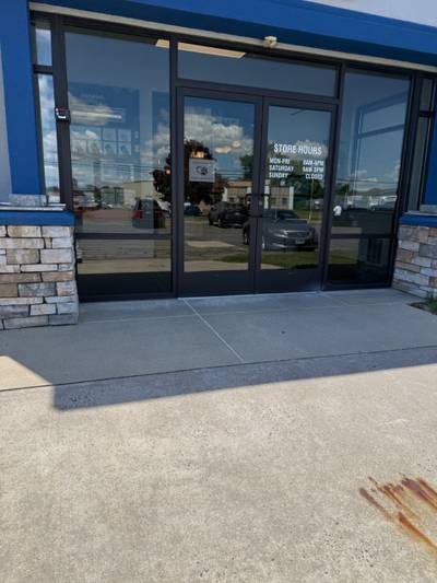 Glass double door storefront with sidewalk