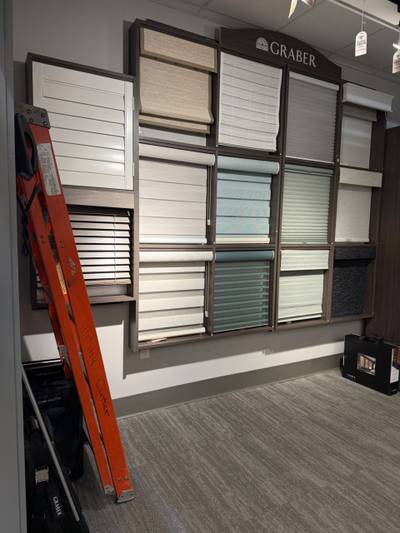 Ladder leaned against window-treatment display wall