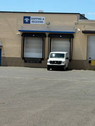 White van parked at warehouse loading docks