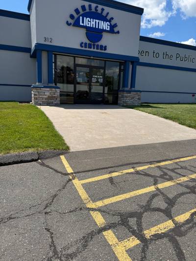 Storefront entrance concrete walkway cracked asphalt lot