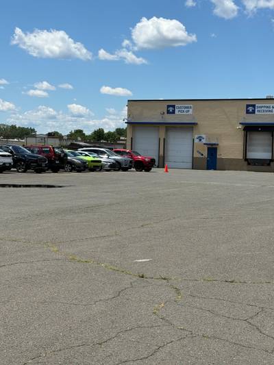 Asphalt parking lot with parked vehicles loading