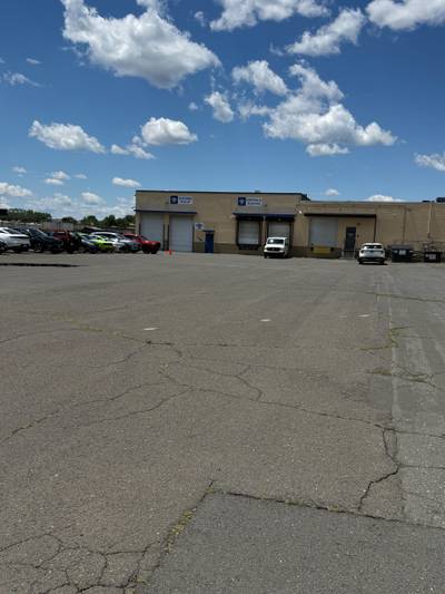 Warehouse loading docks with cracked asphalt lot