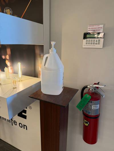 Fire extinguisher and sanitizer jug on stand