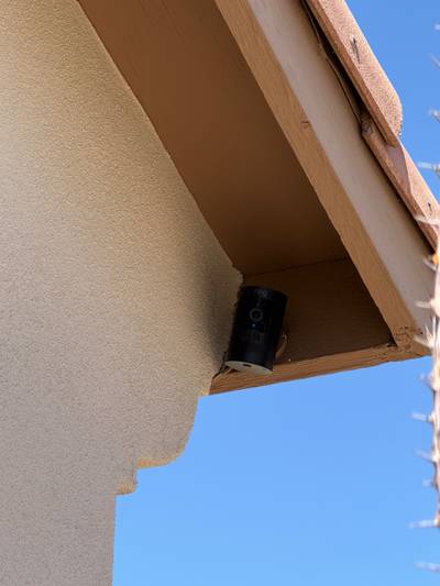 Ring security camera mounted under wood eave