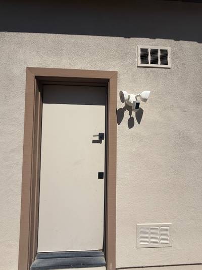 Exterior door with security floodlight camera vents