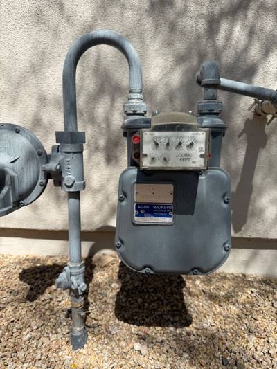 Exterior gas meter and regulator on stucco