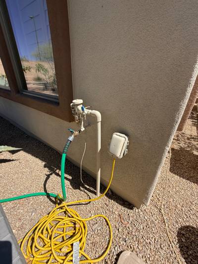 Exterior stucco wall hose bib and outlet