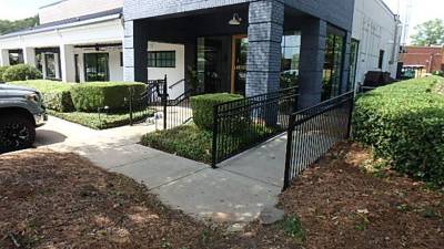 Front entrance walkway with fenced landscape beds
