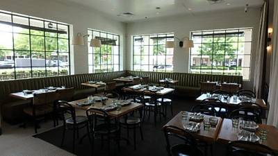 Main dining room, banquette seating with floor mat across tile