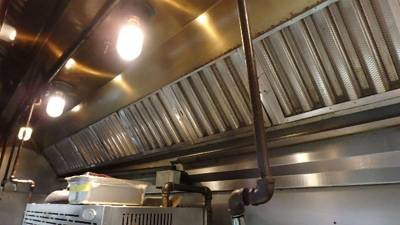 Main exhaust hood with baffle grease filters and enclosed globe lighting