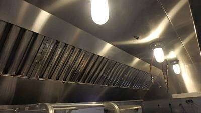 Secondary exhaust hood, angled baffle filters with vapor-proof light fixtures
