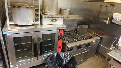 Six-burner gas range with adjacent deep fryer and convection oven