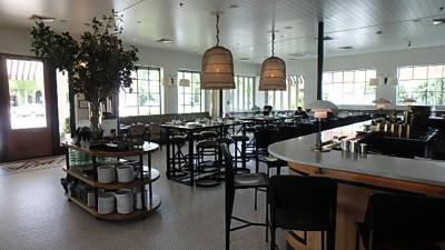High-top dining and curved marble bar with entry-door area rug