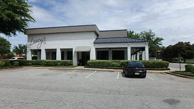 Front parking lot with painted stalls facing entrance portico